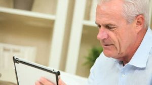 stock-footage-caucasian-senior-gentleman-using-a-wireless-tablet-at-home